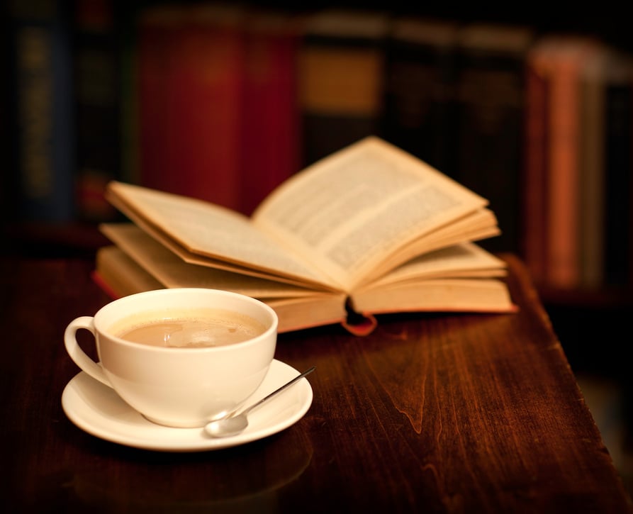 Reading in a library, book shop or cafe